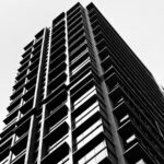 Modern skyscraper viewed from below, black and white.